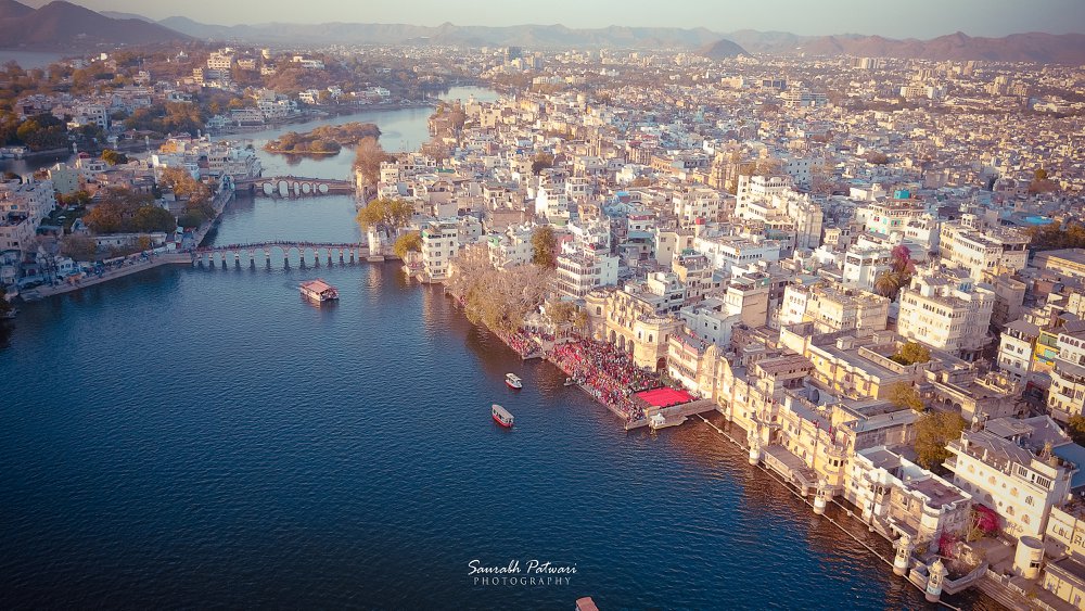 Aerial Drone Photography of Lakecity, Udaipur, Best candid, destination wedding photographers in Udaipur, pre-wedding, wedding, films/highlights, maternity/pregnancy, kids, family, fashion, portfolio event photography, Best Candid Wedding Photographers in Udaipur, Best Destination Wedding Photographers in Udaipur, Best pre-wedding photography, wedding cinematography in Udaipur, Photocare, Best Wedding Photographer in Udaipur established in 1995 Udaipur, Rajasthan based company, Specialize in Cinematic wedding film, candid photography, unique, expressive portfolio, events, best moments, memories, Expertise, Craftsmanship, mordenize, hi-end technology, holistically event, theme, Ceremony, Professional Pre-wedding Shoots Photographers in Udaipur, Hire the best Pre-wedding Shoots,Photographers, Photo Studios in Udaipur, Checkout photographer's portfolio online at photographers, India's largest Photographers Directory, Pre-wedding Shoots, photoshoot collections, ratings, prices, list of Best Wedding Photographers in Udaipur, premium and budget candid photographers, premium and budget photographers, pre wedding photographers in Udaipur, with full quotations, Wedding Photographers in Udaipur for your requirements, Phone number, Portfolio, Latest Reviews, Photos on ShaadiSaga, Best Wedding Photographer in Udaipur, Best Pre Wedding Photographer in Udaipur, Best candid photographer in Udaipur, Destination wedding photographers in Udaipur, pre-wedding photography in udaipur, wedding films/highlights in udaipur, maternity/pregnancy photography in udaipur, kids photography in udaipur, family photography in udaipur, fashion photography in udaipur, portfolio photography in udaipur, event photography in Udaipur, Photos of hotel leela, Photos of hotel chunda palace, Photos of hotel lalit, Photos of hotel oberoi udai villas, Shree Vilas Orchid-By Lake Pichola, Ramada Udaipur Resort and Spa, Kanj Ayaan Resort, Atulya Niwas, Hotel Swaroop Vilas, Taj Lake Palace, Fateh Prakash Palace, Shiv Niwas Palace.